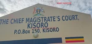 A photograph of the facade of The Chief Magistrate's Court in Kisoro, Uganda. The building features large blue text identifying the institution and displays the Ugandan coat of arms above the name, alongside the national flag colors.
