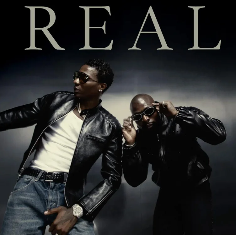 Promotional image for the collaborative EP 'Real' featuring Nigerian artists Wizkid and Asake. Both artists are dressed in stylish black leather jackets and sunglasses, posed against a dark, moody background with the title 'REAL' prominently displayed at the top.