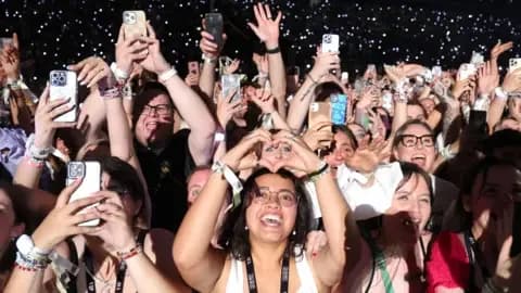 Getty Images Fans watch Taylor Swift perform onstage during night two of Taylor Swift: The Eras Tour at La Defense on 10 May, 2024 in Paris, France.