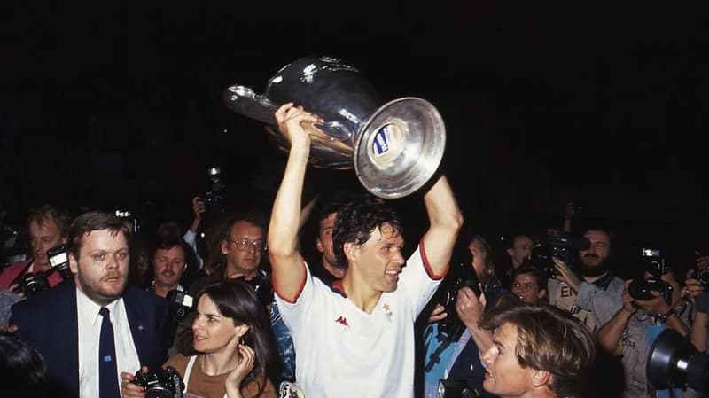 Marco van Basten of AC Milan lifts the trophy after winning the 1990 European Cup final