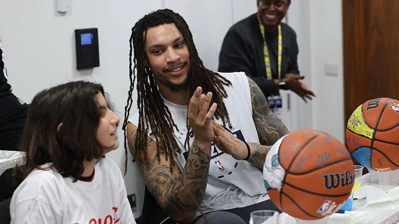 Brandon Clarke of the Memphis Grizzlies speaks to a young girl at an NBA community event in London in January 2026