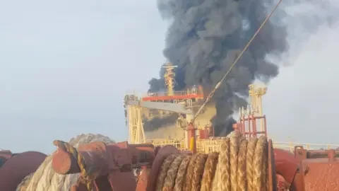 Sunil Pereira Smoke and flamies plume from the bow of Skylight after it was hit by a missile