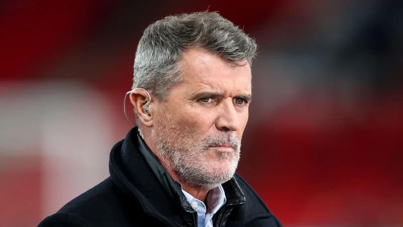 Roy Keane working as a pundit in a dark coat and with an earpiece in his left ear