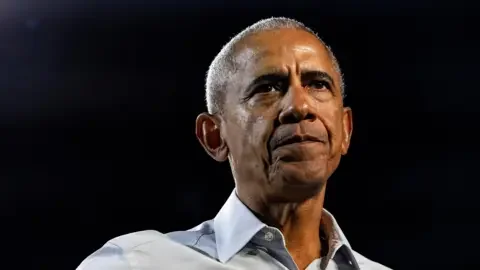 Reuters Close up of Barack Obama with a serious expression. He is wearing a pale shirt.