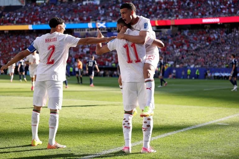 FOXBOROUGH, MASSACHUSETTS - JUNE 19: Ismael Saibari #11 of Morocco celebrates with teammates Achraf Hakimi #2 and Bilal El Khannouss #23 after scoring his team's first goal during the FIFA World Cup 2026 Group C match between Scotland and Morocco at Boston Stadium on June 19, 2026 in Foxborough, Massachusetts. (Photo by Justin Setterfield/Getty Images)