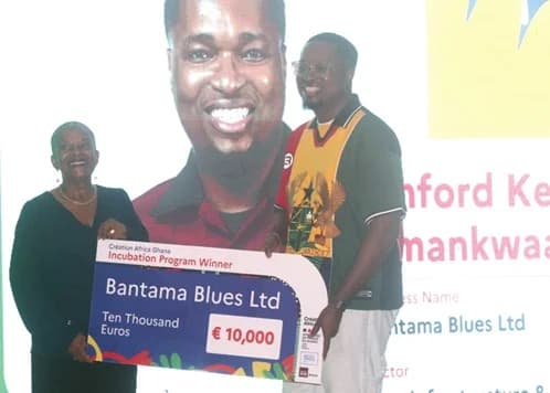 Linford Kennedy Amankwa (right), Bantama Blues Ltd, receiving the €10,000 grant cheque from Christiane Tuabira, a former French Minister of Justice