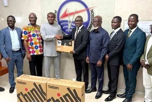 Dr Shafic Suleman (3rd from left), Executive Secretary, PURC, handing over laptop computers to Prof. Dennis Aheto (4th from right), Vice-Chancellor, UCC