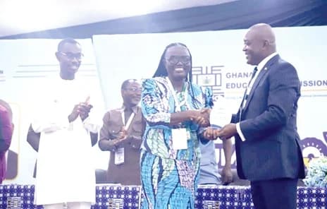 Prof. Ahmed Abdulai Jinapor (right), Director-General, Ghana Tertiary Education Commission, presenting a citation to Prof. Rita Akosua Dickson, Vice-Chansellor, KNUST, during the opening of the GTEC Summer School in Kumasi. Applauding is Ben Abdallah Alhassan (left), MCE for Asokore Mampong. Picture: EMMANUEL BAAH