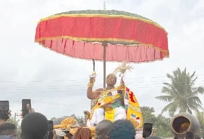 Nana Aba Kum I, the Mpuntuhemaa of Badukrom/Kokwado in the Ajumako Enyan Essiam District in the Central Region, being carried on a palanquin