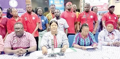 Gifty Abena Turkson (seated 2nd from left), Deputy General Secretary of TEWU-TUC, speaking at the press conference