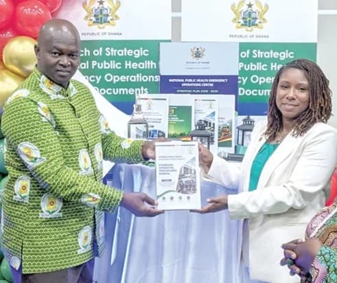 Dr Danielle Barradas (right), US CDC in Ghana, and Dr Samuel Kaba Akoriyea, Director-General of the Ghana Health Service, launching the document for the strategic roadmap