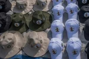 Merchants sold hats with the image of the king, who died at age 34. By Badru KATUMBA (AFP)