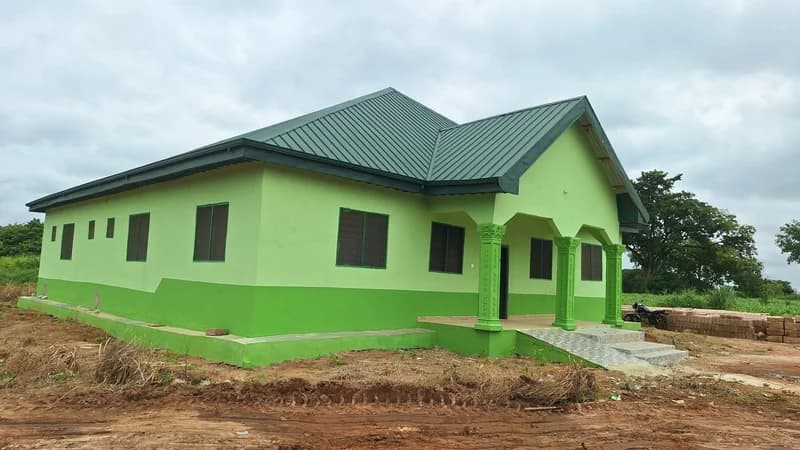 A photograph of a newly constructed, bright green building identified as the new Community-based Health Planning and Services (CHPS) compound in Nyankontre. The modern facility features a dark green roof, several windows, and an accessible ramp at the entrance, replacing an older makeshift clinic.