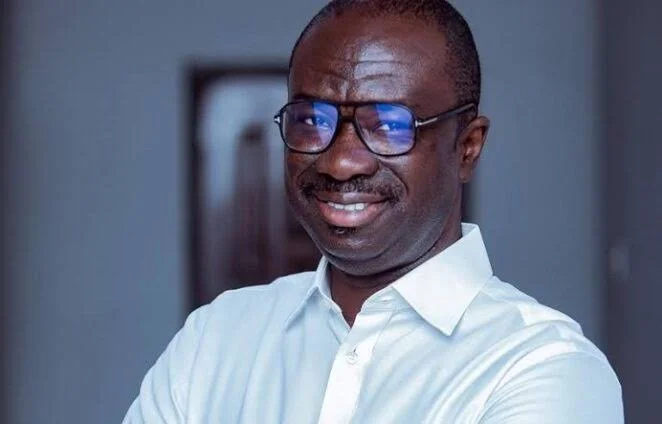 A medium close-up portrait of Ignatius Baffour-Awuah, a prominent Ghanaian politician. He is depicted wearing a white collared shirt and dark-rimmed spectacles, smiling slightly towards the lens in an indoor setting with a shallow depth of field.