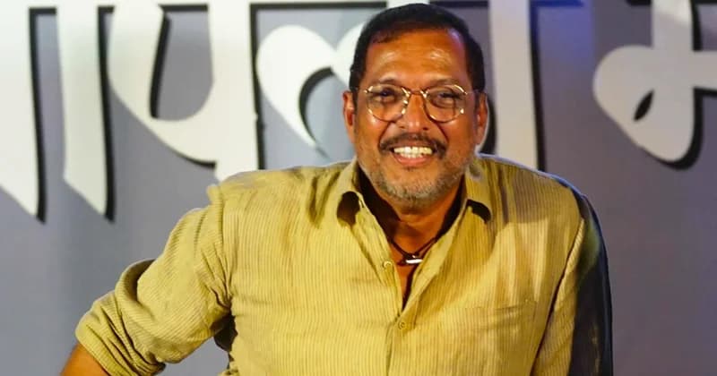 A portrait of Indian actor Nana Patekar smiling at a public event. He is wearing round-framed glasses and a tan button-up shirt, standing in front of a grey background with large white Devanagari script.