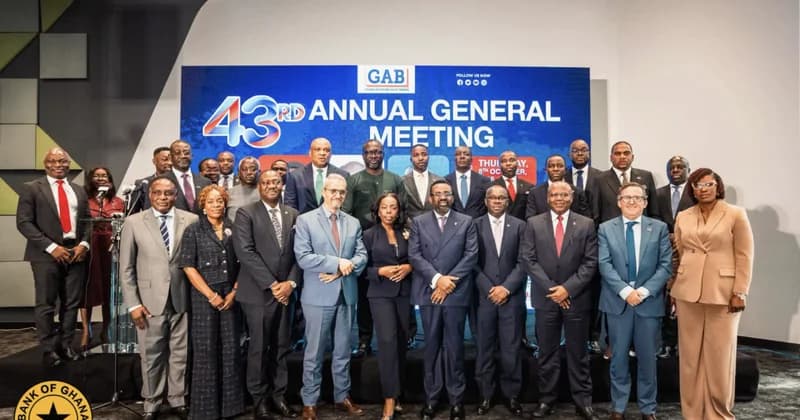 A group of banking executives and professionals pose for a formal photograph at the Ghana Association of Banks (GAB) 43rd Annual General Meeting. Dr. Ernest Addison, the Governor of the Bank of Ghana, is standing in the front row among other industry leaders in front of a blue promotional backdrop.