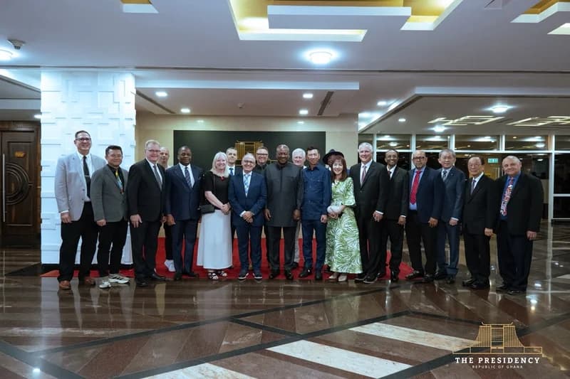 President John Dramani Mahama stands at the center of a group photograph with executives from the Assemblies of God church. The group is gathered in a modern, brightly lit reception hall with polished stone floors, following a meeting ahead of the World Congress in Accra.