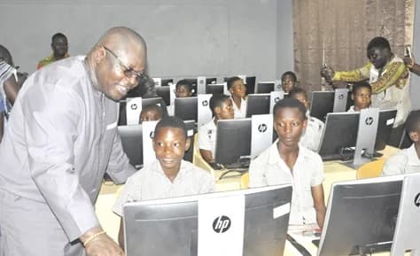 Mawutor Agbavitor, Volta Regional Chairman of the NDC, being taken through a programme by a learner at the school