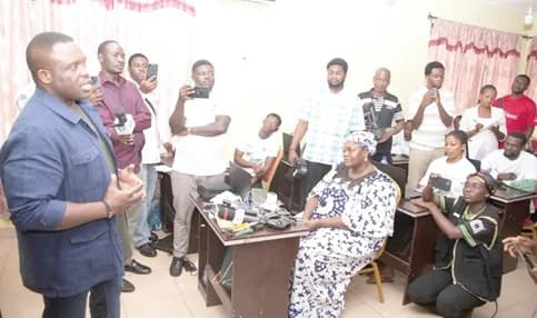Samuel Nartey George (left), Minister of Communications, Digital Technology and Innovations, addressing some of the coders undergoing training at the Kwadaso Regional Information Centre