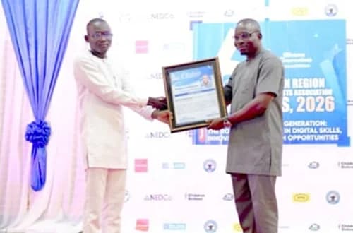 Abukari Alhassan Baba (left) receiving a citation from Abdul Mumin Ewuntomah (right), District Chief Executive for North East Gonja, at the awards