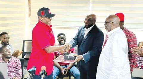 Ace Anan Ankomah (MOBA ’84), presenting the Mfantsipim Sesquicentennial Anthology to Kwadwo Morgan (middle), Executive Secretary, 150th Anniversary, as Captain Johnny Yamoah (right), Chairman, Anniversary Planning Committee, looks on