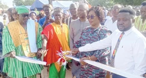Diana Asoketarige Ayamga (2nd from right), Bongo DCE, being supported by Naba Baba Salifu Tamale Lemyaarum (left), Paramount Chief of Bongo; Naba Atanga Abelinziire, Chief of Kadare; and Asambo Isaac Assibi (right), President of the Bolgatanga Branch of the Church of Jesus Christ of Latter-day Saints, to cut the tape for the inauguration of the project (inset)