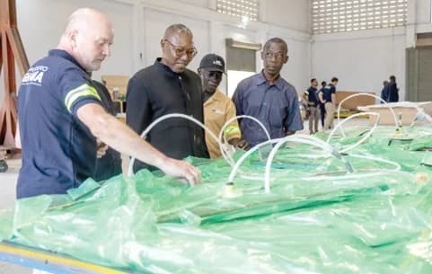 Jensen Jorgen (left), one of the trainers, explaining a point to Dr Clement Abas Apaak (2nd from left), Deputy Education Minister