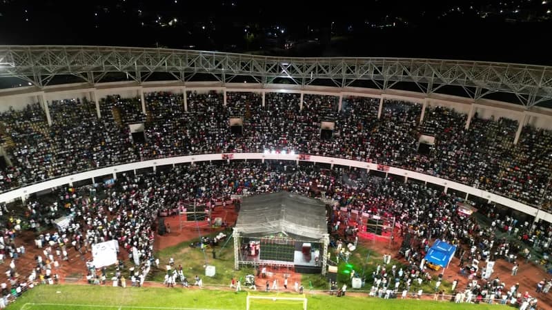 An aerial wide-angle photograph capturing a massive crowd gathered at the Aliu Mahama Sports Stadium in Tamale for Fad Lan's Homecoming Concert. The image shows the stadium stands filled to capacity and a large stage set up on the pitch, illuminated by stadium lights during the nighttime event.