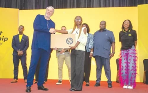 Stephen Blewett (left), Chief Executive Officer, MTN Ghana, presenting a laptop to one of the beneficiary students. Picture: DOUGLAS ANANE-FRIMPONG