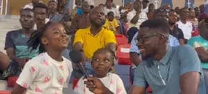 John Antwi receives support from children during Basake Holy Stars match