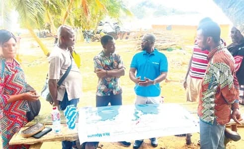 Stephen Kankam (4th from left), Deputy Director of Hen Mpoano, using a map that links the forest and MPA to explain to journalists the need to protect the forest