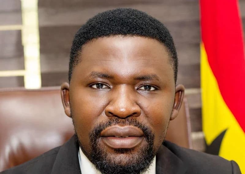A professional headshot of Justice Kojo King, the National Executive Director of the Ghana National Council of Private Schools (GNACOPS). He is seen wearing a dark suit and white shirt, with a portion of the Ghanaian flag visible in the background.