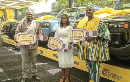 Samuel Obeng, Benedicta Obeng Asare and So-Otey Medintey, grand-prize winners of the MTN Ghana 30th Anniversary Mega Promotion, pose by their vehicles after the awards ceremony. Picture: DOUGLAS ANANE-FRIMPONG