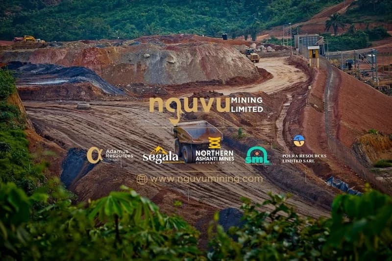 An aerial photograph of an open-pit mining operation showing a haul truck on a dirt road amidst excavated hills. The image is professionally overlaid with the logos of Nguvu Mining Limited and its subsidiaries, including Northern Ashanti Mines Company Limited, which is the subject of the news article.