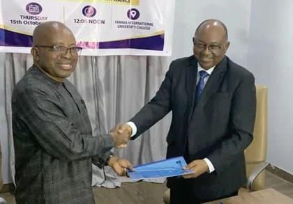 Alexander Williams (right), Chief Executive Officer, GISI, exchanging documents with Professor Samuel Agyei-Ampomah, Rector of FIUC, after the signing