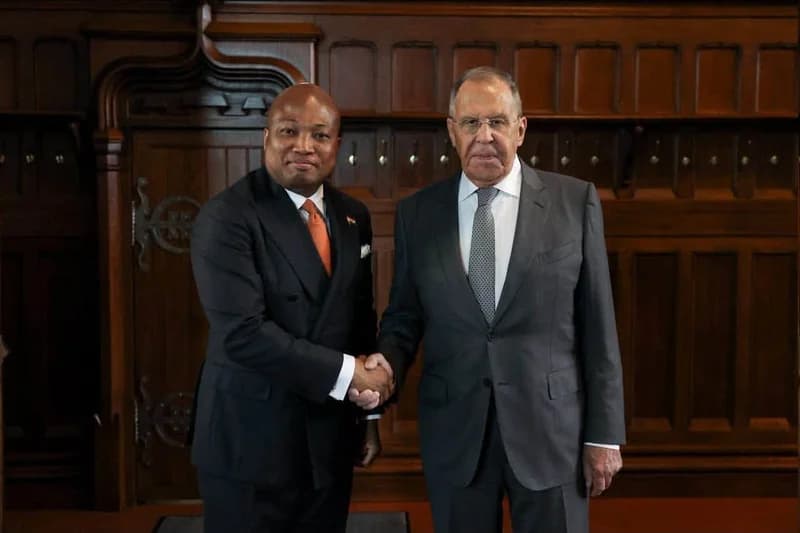 A formal photograph showing Ghanaian Member of Parliament Samuel Okudzeto Ablakwa shaking hands with Russian Foreign Minister Sergey Lavrov. The two diplomats are standing in front of an ornate dark wood-paneled background during a high-level bilateral meeting.