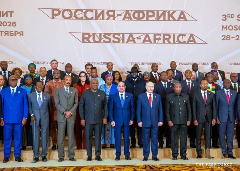 A group photograph featuring Russian President Vladimir Putin and various African heads of state, including Ghanaian President John Mahama, at a Russia-Africa summit. The leaders are posed in multiple rows against a backdrop with bilingual branding in Russian and English.